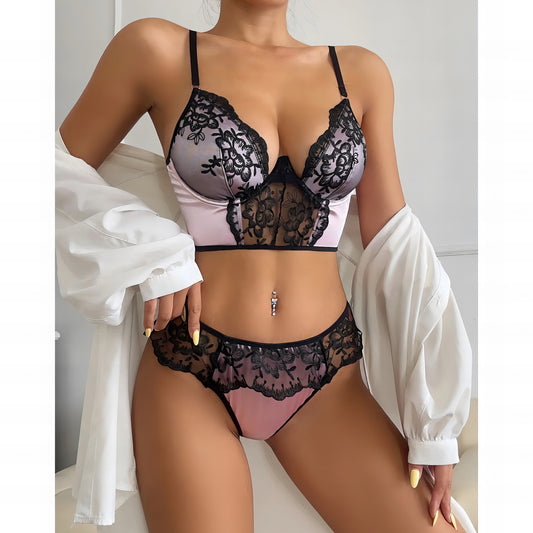 Woman wearing a pink mesh 2-piece lingerie set with embroidery, posing on a white background