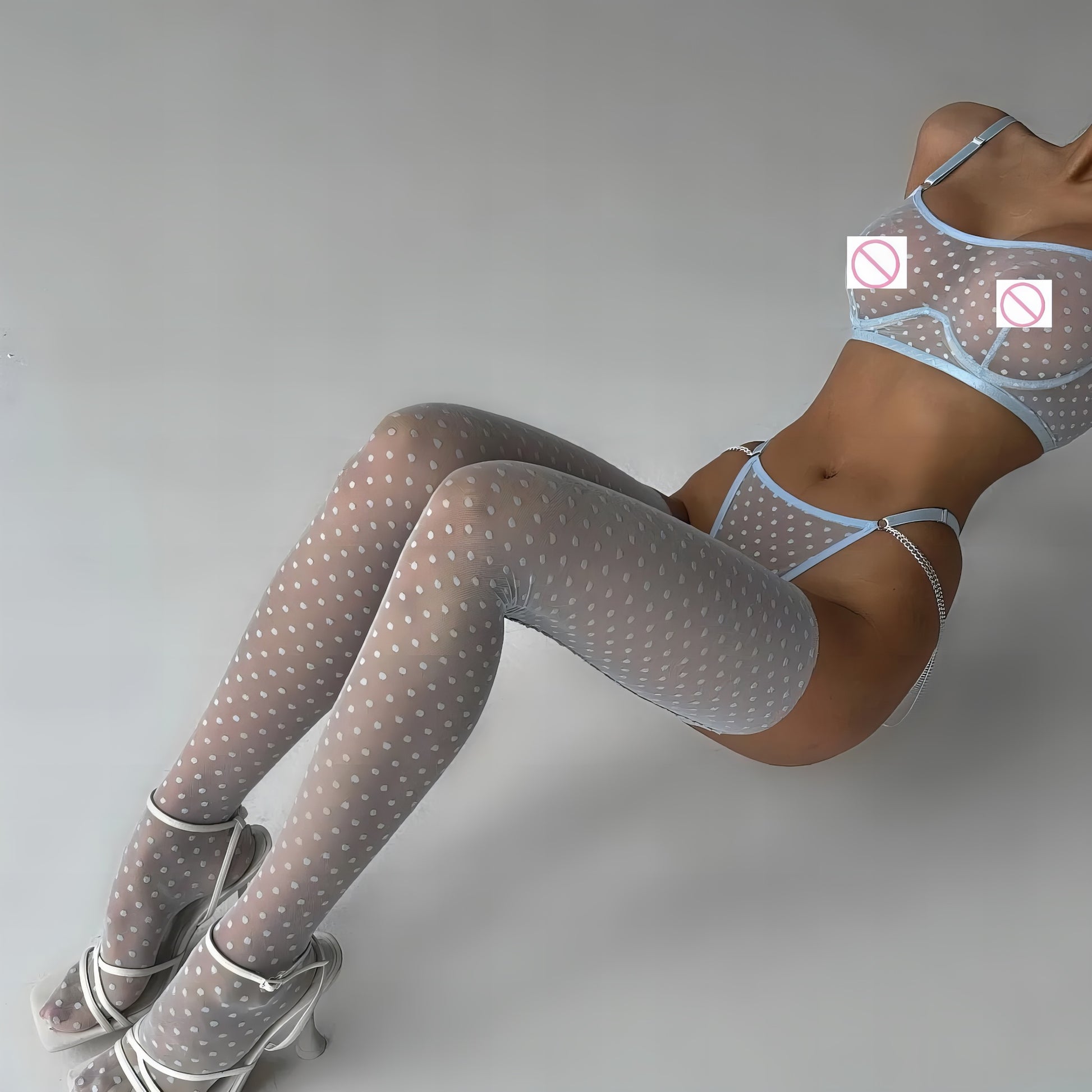 Woman wearing a blue mesh 2-piece lingerie set with embroidery, posing on a white background