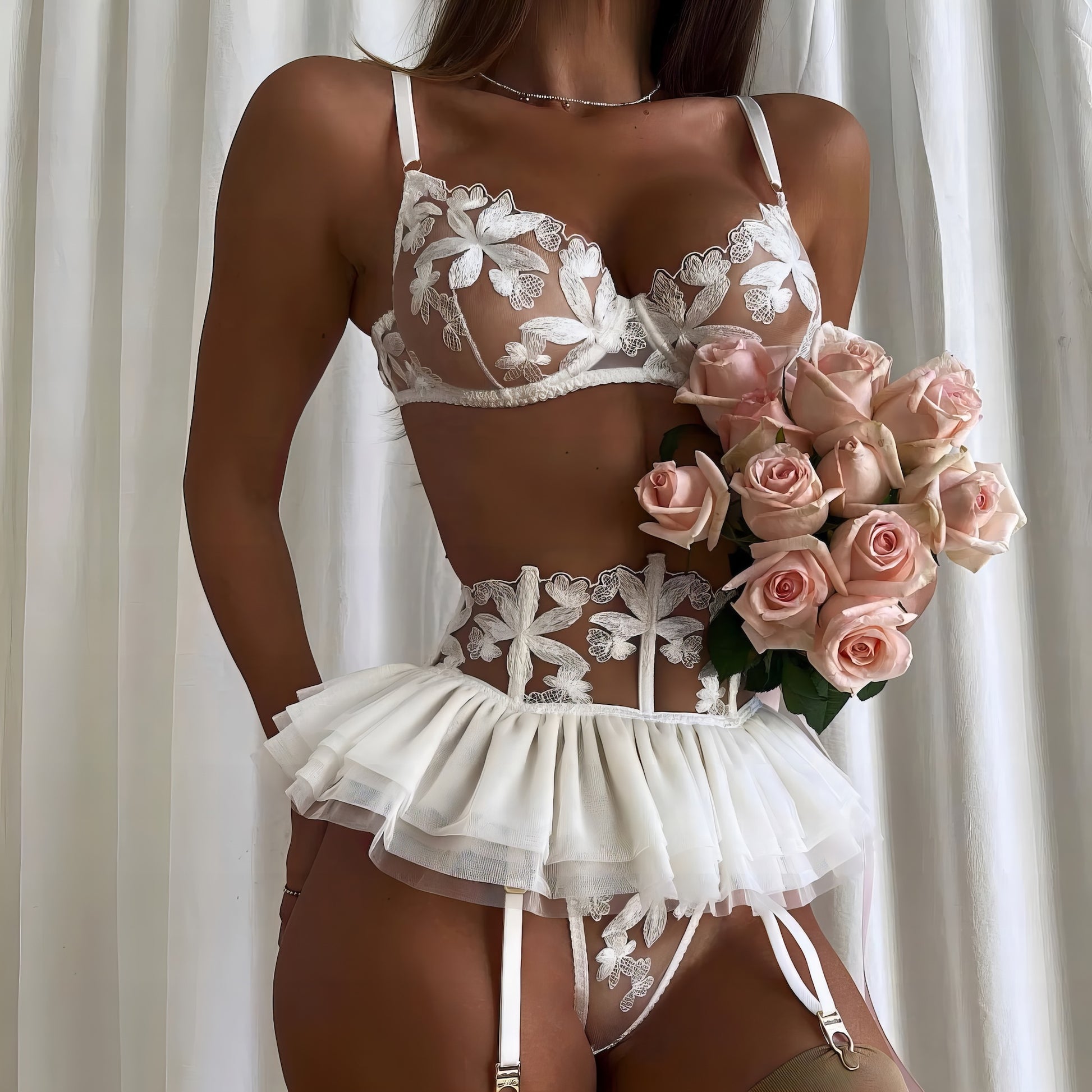Woman wearing a white mesh 2-piece lingerie set with embroidery, posing on a white background