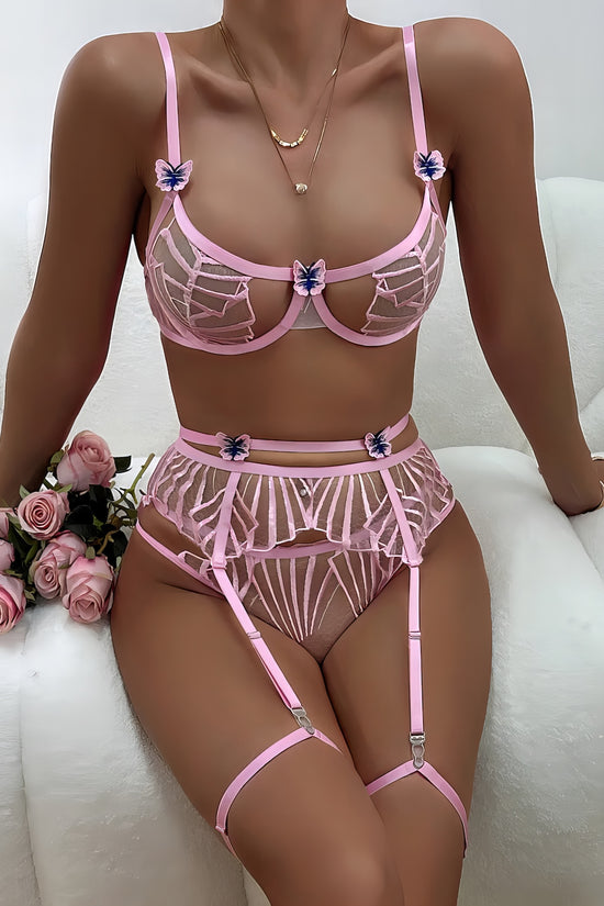 Woman wearing a pink mesh 2-piece lingerie set with embroidery, posing on a white background