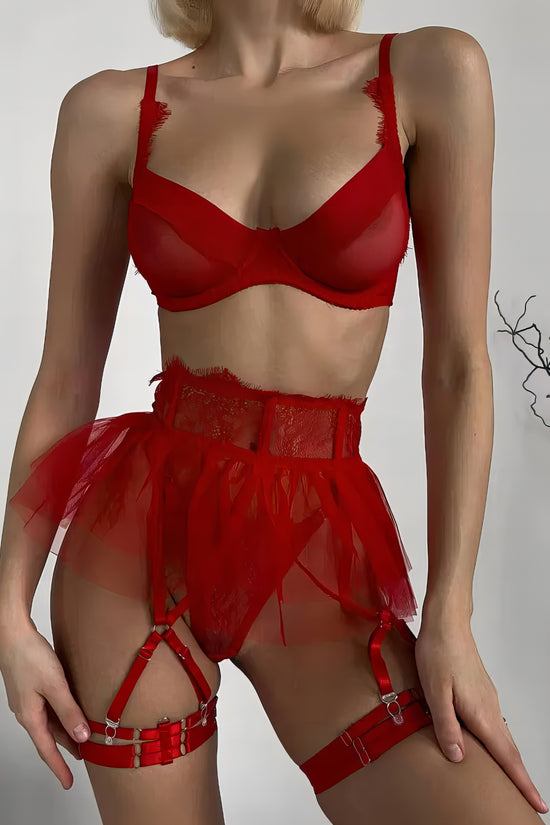 Woman wearing a luxury red mesh 3-piece lingerie set with pink floral embroidery, including underwire bra, garter belt, and matching thong