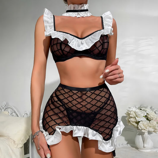 Woman wearing a luxury black znd white mesh 3-piece lingerie set with pink floral embroidery, including underwire bra, garter belt, and matching thong