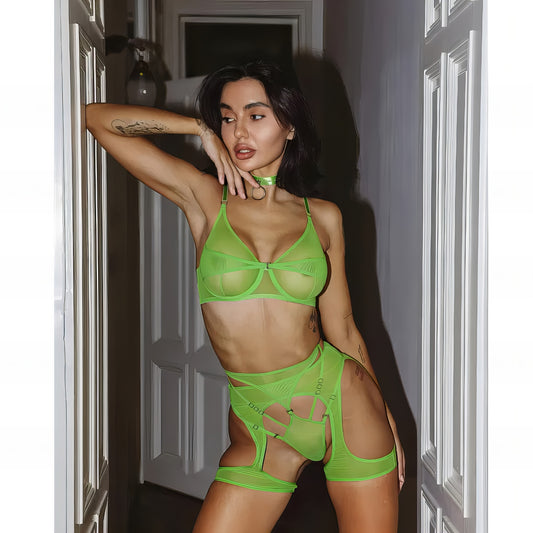 Woman wearing a luxury green mesh 3-piece lingerie set with embroidery, including underwire bra, garter belt, and matching thong