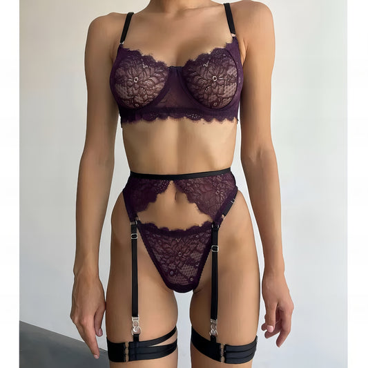 Woman wearing a luxury purple mesh 3-piece lingerie set with embroidery, including underwire bra, garter belt, and matching thong 