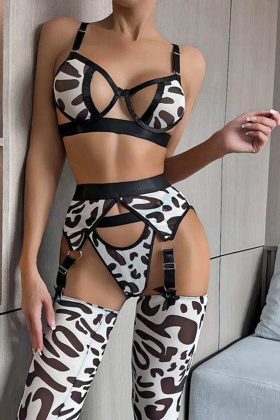Woman wearing a luxury white mesh 3-piece lingerie set with embroidery, including underwire bra, garter belt, and matching thong