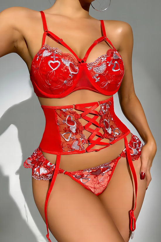 Woman wearing a red mesh 2-piece lingerie set with silver embroidery, posing on a white background