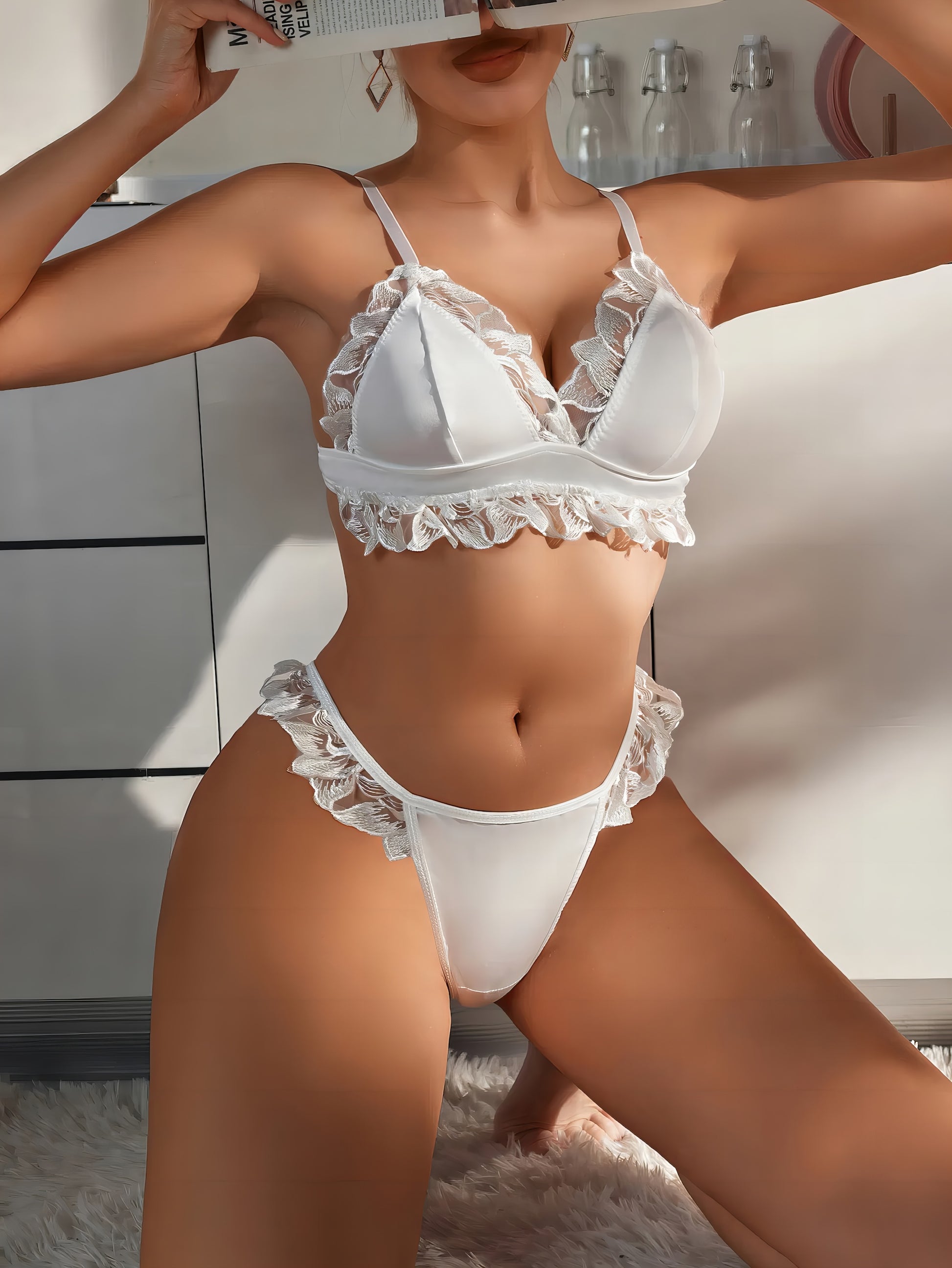 Woman wearing a white mesh 2-piece lingerie set with white embroidery, posing on a white background