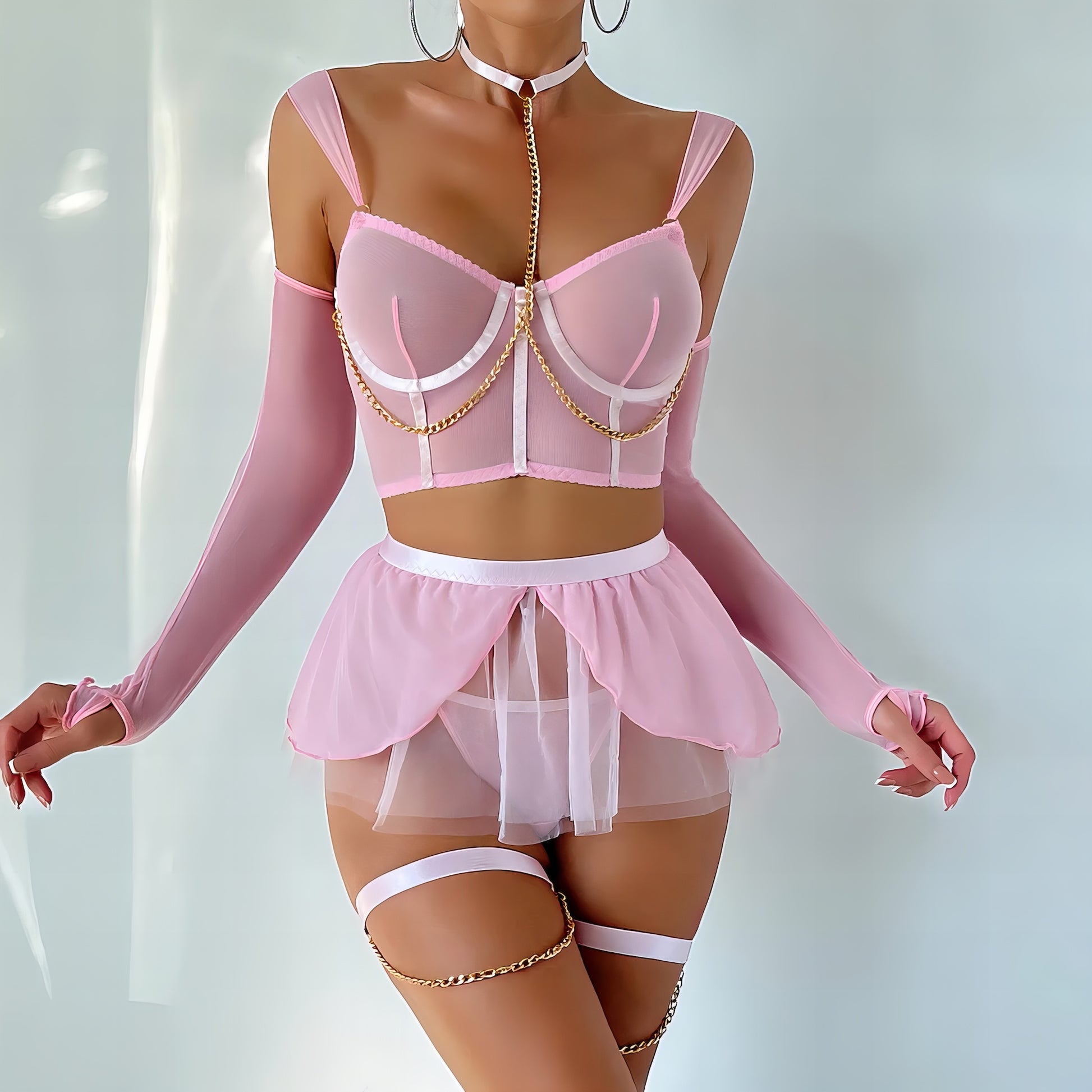 Woman wearing a luxury pink mesh 3-piece lingerie set with embroidery, including underwire bra, garter belt, and matching thong 